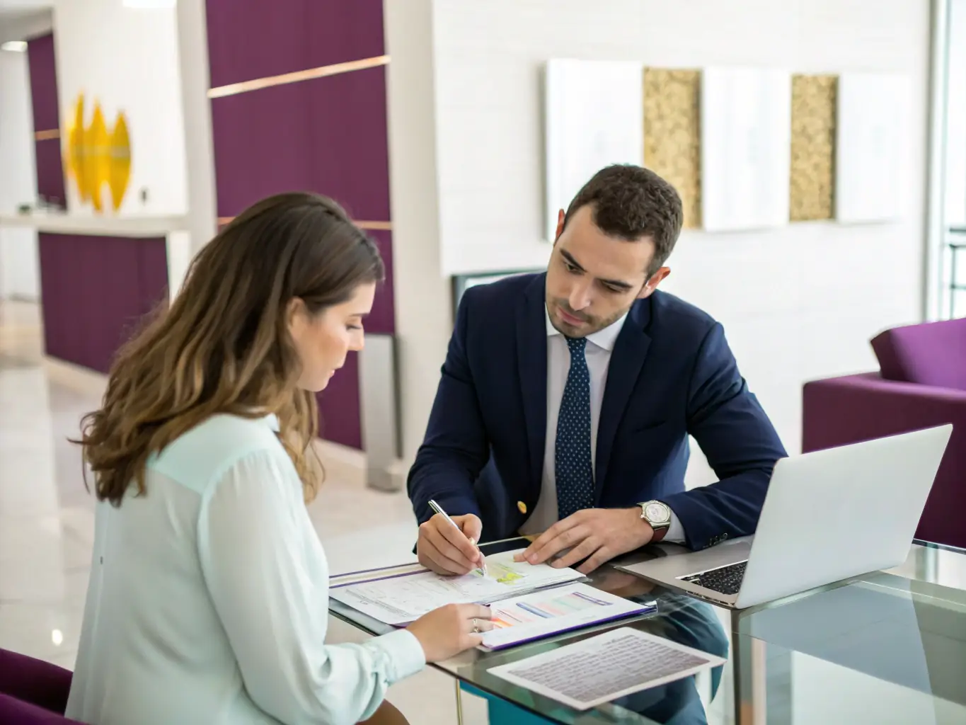 A financial advisor reviewing investment portfolios with a client, discussing financial planning and risk management strategies.